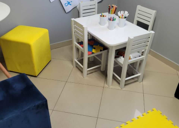 Sala do consultório com mesa e lápis de cores para as crianças